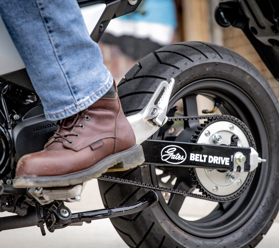 Close-up of Honda Grom belt drive system showing rear sprocket, belt, and sprocket.