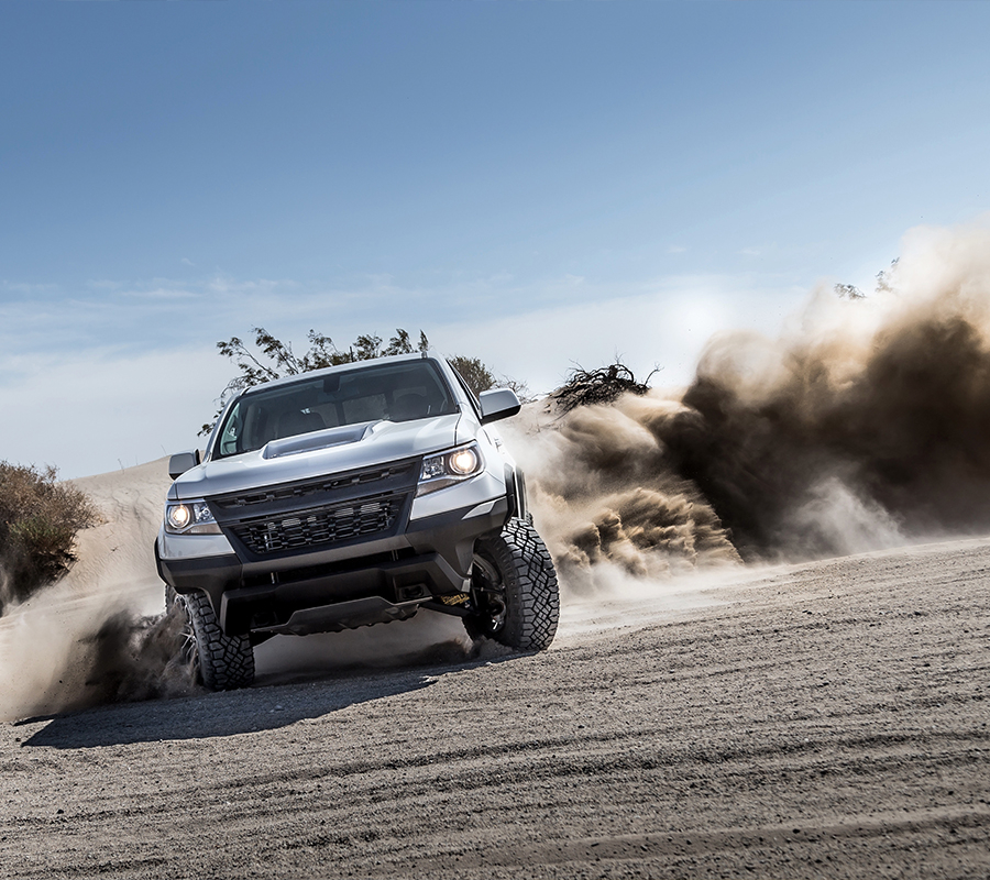 A truck navigating a rugged dirt road, showcasing its impressive off-road performance.