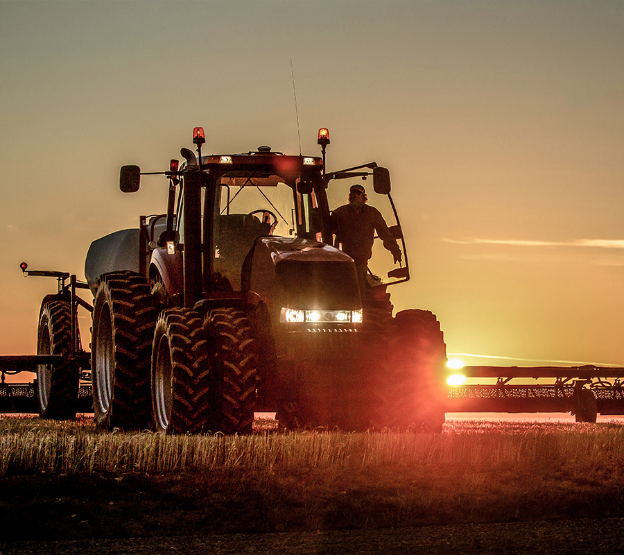 A parked tractor in a field, exemplifying its efficiency and performance in agricultural operations.