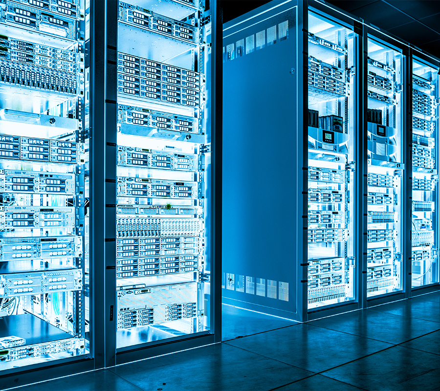 A large, tech-filled room featuring numerous servers and computers, highlighting a modern data center setup.
