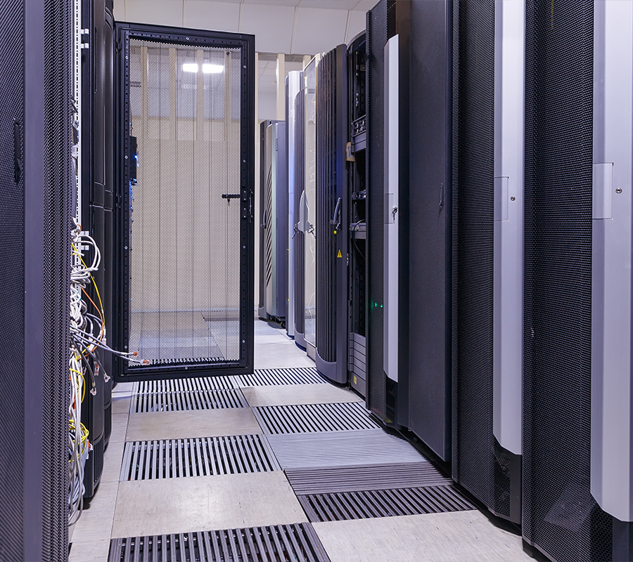 black and grey images of a data center server hall with multiple cabinets and floor grates