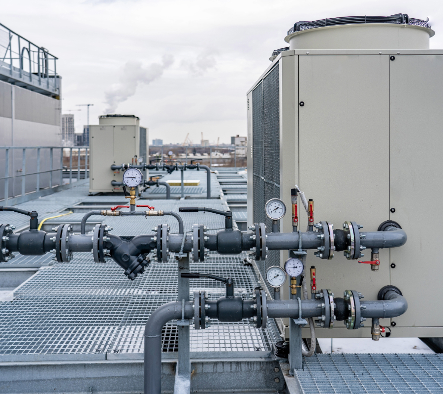 Industrial chiller system with pipes and pressure gauges on a rooftop