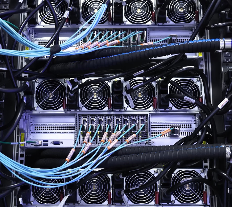 black and grey image of a complicated server rack with large ID hoses connecting to a manifold