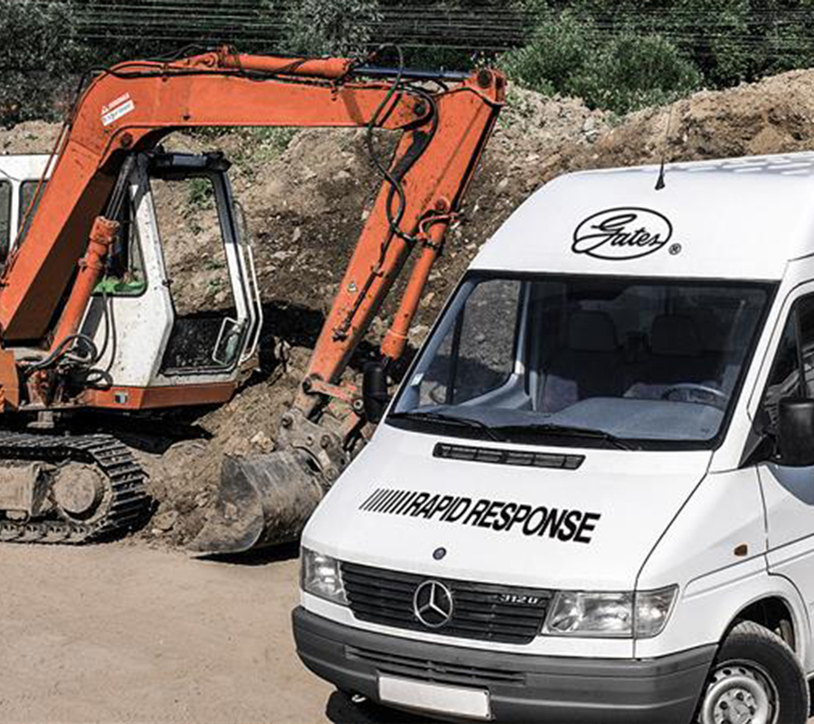 White Gates® Rapid Response vehicle parked next to an orange excavator