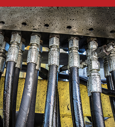 A series of hose connected to a machine with couplings.