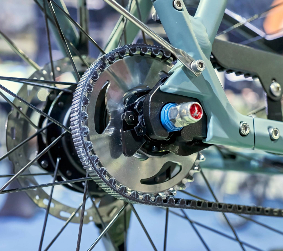 a bicycle's drive system close up showing belts and sprockets