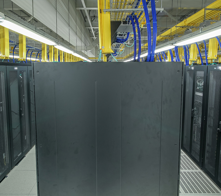 full color image of black server racks and yellow overhead data center pipe accessories