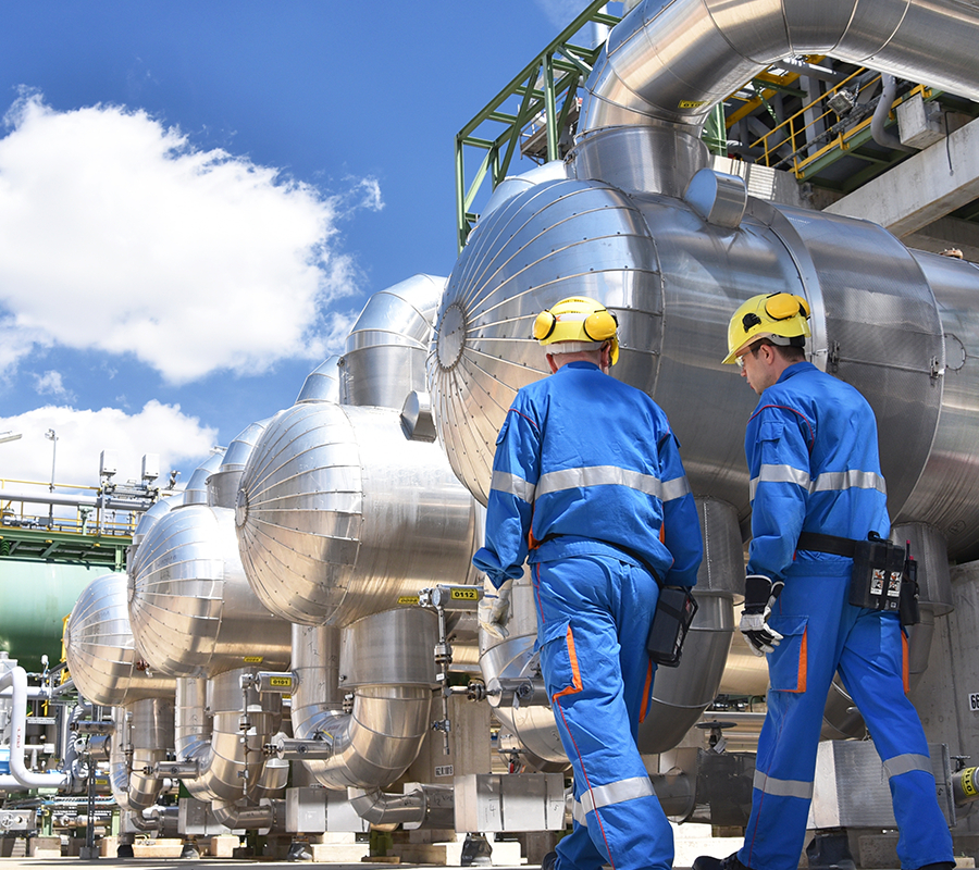 Two maintenance technicians walking at a processing plant.