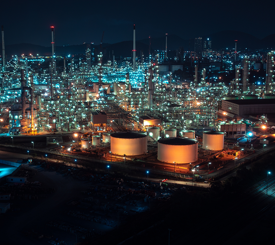 Aerial view of a petrochemical processing plant at night.