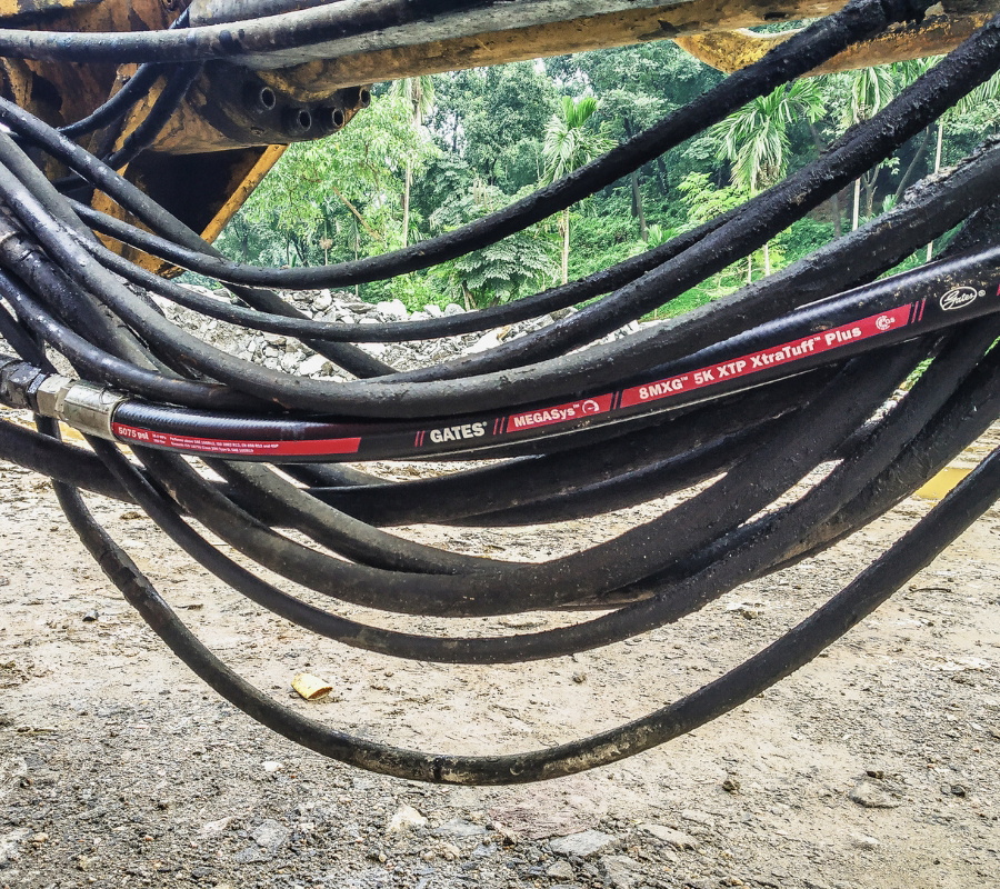 MXG™ HYDRAULIC HOSE SERIES being used outdoors