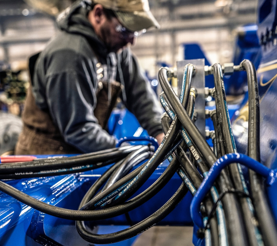 Man adjusting MXT-XTP HYDRAULIC HOSE 