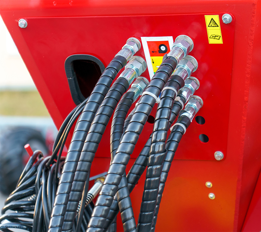 red truck with hydraulic hose and coupling assemblies