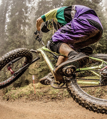 mountain bikers riding his bike uphill 