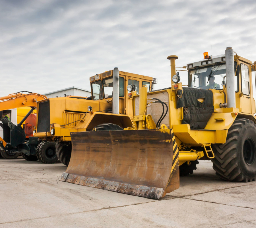 Heavy-duty wheeled tractor, along with additional construction machinery on-site.