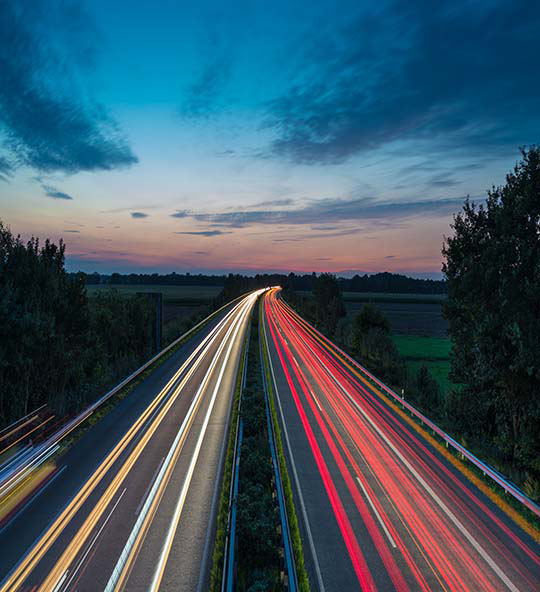 Yellow and red light tracks from cars on the highway in the evening after sunset