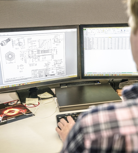 Engineer viewing drawings on computer screens