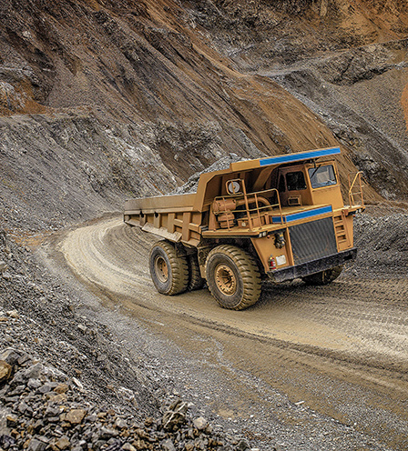 Dump Truck hauling a load of aggregates near a surface mine